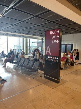 BER Terminal 1 concourse A directional sign pointing toward gates A01, A02, BCD and Lufthansa Lounge