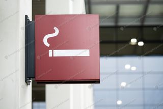 Red wall-mounted BER smoking area sign with cigarette pictogram at terminal entrance