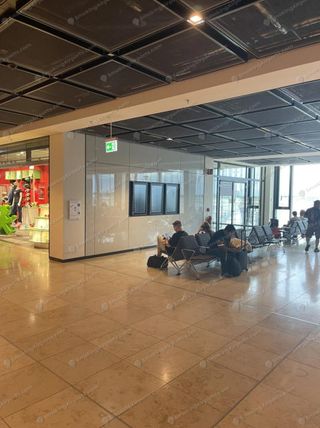 Enclosed glass smoking room on Terminal 1 Level E1 between Gates B02 and B03 at BER