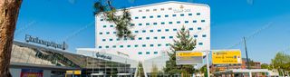 Eindhoven Airport terminal entrance forecourt with Tulip Inn hotel and directional signage