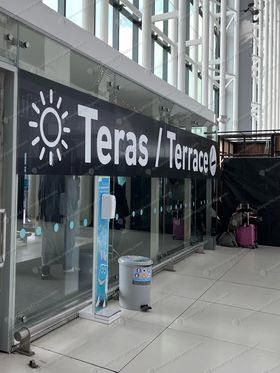 Teras Terrace banner sign on glass sliding doors of smoking area near Gate D at Istanbul Airport (2)