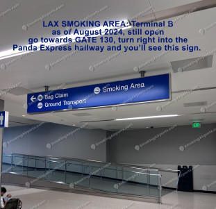 Blue overhead sign in TBIT Terminal B directing travelers to LAX smoking area near Gate 130