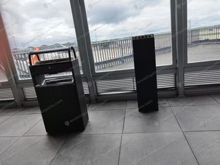 Ashtray and cigarette bin beside floor-to-ceiling windows overlooking Orly apron