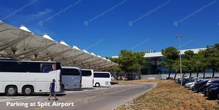 Split Airport outdoor parking area with white coaches under tensile canopy